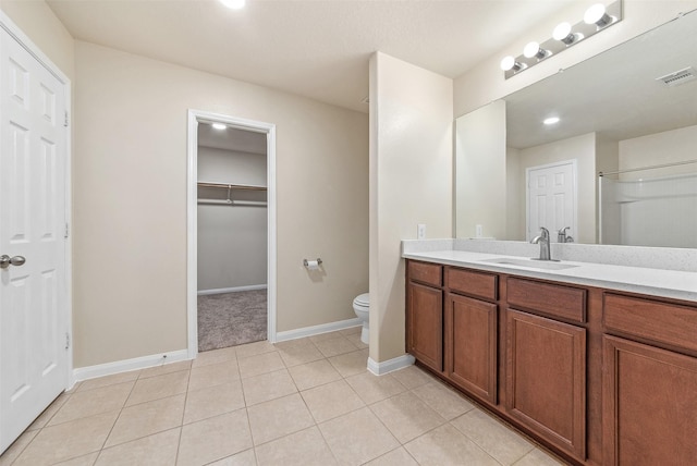 6906 Chessgate Falls Ln, Rosenberg, TX 77469 - bathroom with toilet, vanity, tile patterned flooring, baseboards, and visible vents