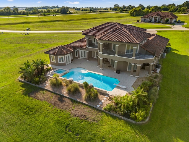 134 Mia Lago Dr, Montgomery, TX 77356 - back of property with a pool with connected hot tub, stucco siding, a patio area, a balcony, and a lawn