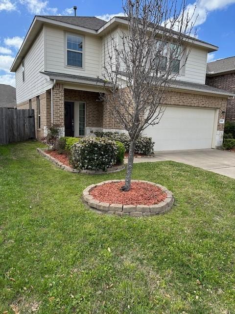 13830 Bonner Bluff Ln, Houston, TX 77047 - traditional home featuring driveway, fence, a front yard, an attached garage, and brick siding
