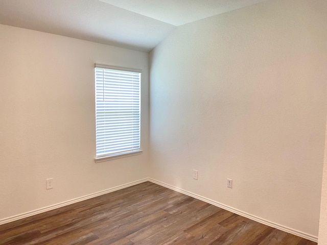 unfurnished room with plenty of natural light, dark wood-style floors, and baseboards