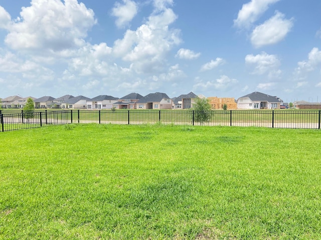 view of yard with fence and a residential view