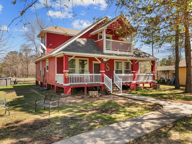 1151 County Line Rd, Shepherd, TX 77371 - view of front facade with a balcony, a porch, a front lawn, and roof with shingles