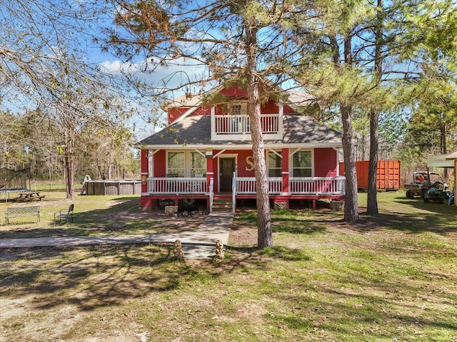 1151 County Line Rd, Shepherd, TX 77371 - view of front of home featuring a balcony, a trampoline, and a front lawn