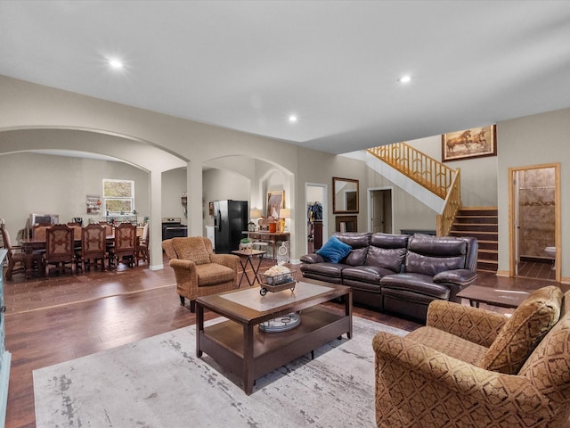1151 County Line Rd, Shepherd, TX 77371 - living room featuring stairway, recessed lighting, wood finished floors, and arched walkways