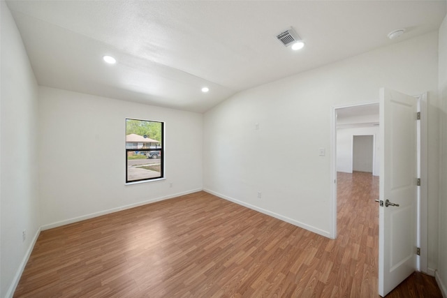5610 Belarbor St, Houston, TX 77033 - unfurnished room featuring baseboards, visible vents, recessed lighting, vaulted ceiling, and light wood-type flooring