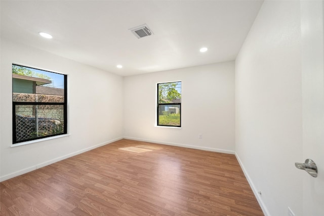 5610 Belarbor St, Houston, TX 77033 - empty room featuring visible vents, recessed lighting, baseboards, and wood finished floors
