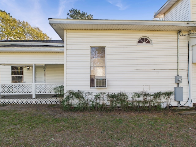 view of side of property with a lawn and a porch