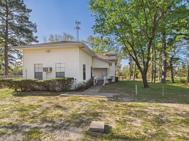 back of property with a lawn