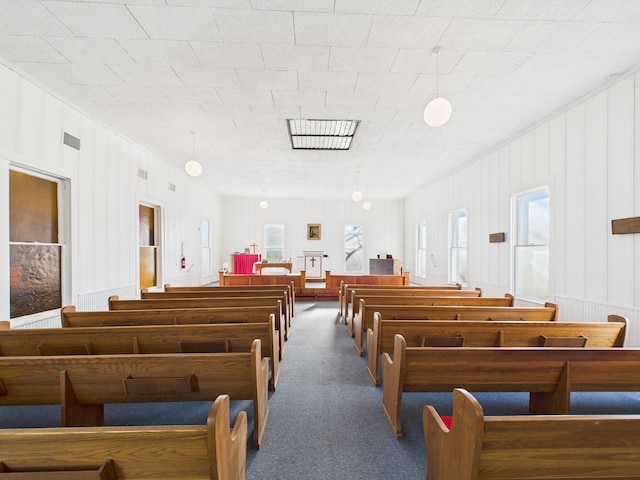 misc room featuring visible vents and carpet