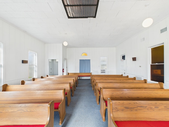 carpeted dining room featuring visible vents