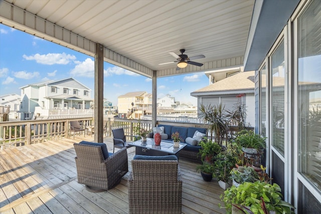deck featuring an outdoor hangout area, ceiling fan, and a residential view