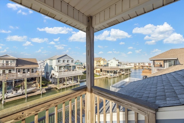 balcony featuring a residential view and a water view