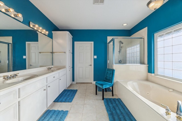 bathroom with a sink, a stall shower, and visible vents