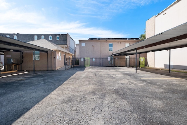 215 Postoffice St Unit 702, Galveston, TX 77550 - covered parking lot featuring fence and a gate