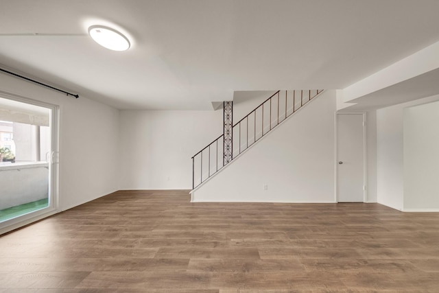 215 Postoffice St Unit 702, Galveston, TX 77550 - unfurnished living room featuring stairway and wood finished floors
