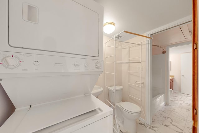215 Postoffice St Unit 702, Galveston, TX 77550 - bathroom with stacked washer and clothes dryer, marble finish floors, a shower, and toilet