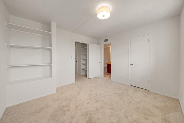 215 Postoffice St Unit 702, Galveston, TX 77550 - unfurnished bedroom with carpet flooring, baseboards, and connected bathroom