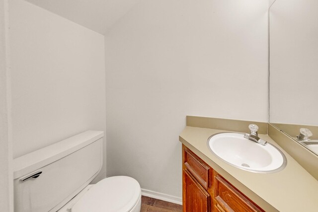 215 Postoffice St Unit 702, Galveston, TX 77550 - half bath with toilet, vanity, baseboards, and wood finished floors