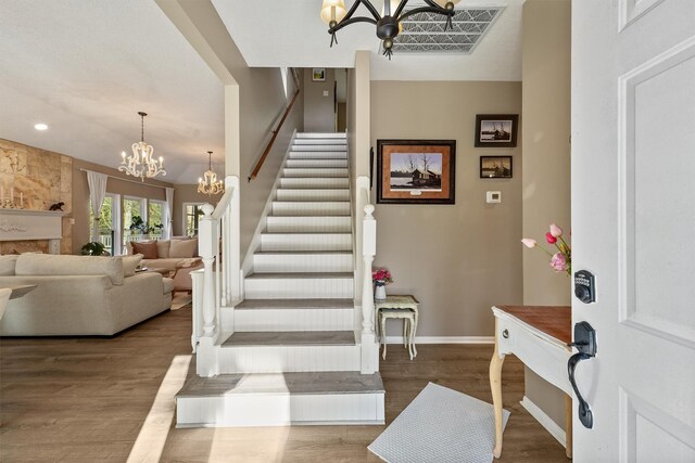 1518 Honea Egypt Rd, Magnolia, TX 77354 - entryway with baseboards, stairway, an inviting chandelier, and wood finished floors