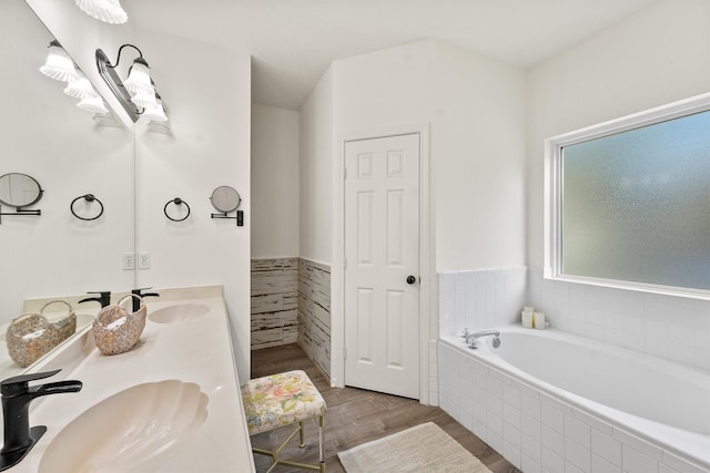 1518 Honea Egypt Rd, Magnolia, TX 77354 - bathroom with a bath, wood finished floors, double vanity, and a sink