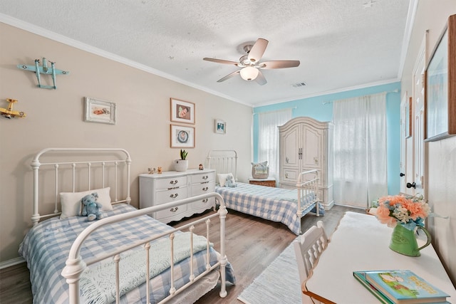 1518 Honea Egypt Rd, Magnolia, TX 77354 - bedroom with a textured ceiling, wood finished floors, ornamental molding, and visible vents