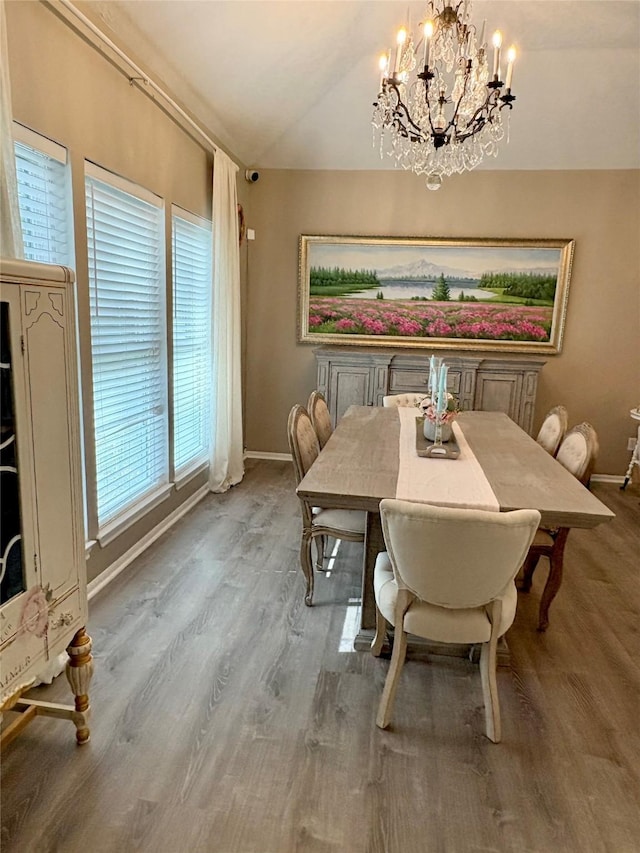 1518 Honea Egypt Rd, Magnolia, TX 77354 - dining space featuring a chandelier, baseboards, vaulted ceiling, and wood finished floors