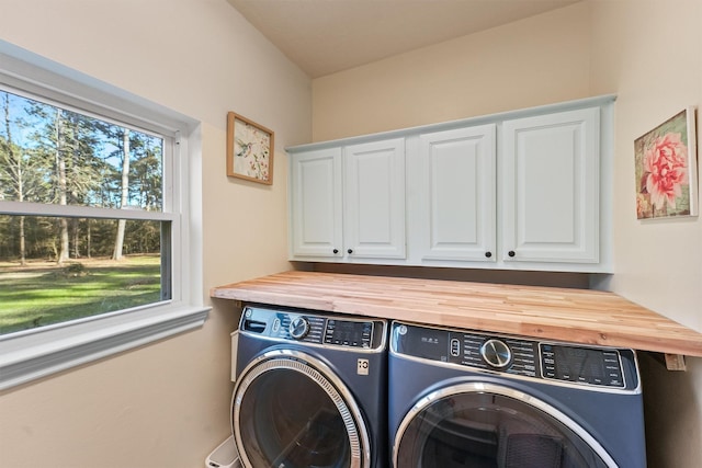 1518 Honea Egypt Rd, Magnolia, TX 77354 - clothes washing area featuring cabinet space and washing machine and dryer