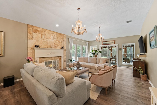 1518 Honea Egypt Rd, Magnolia, TX 77354 - living area with a textured ceiling, an inviting chandelier, visible vents, and dark wood-style flooring