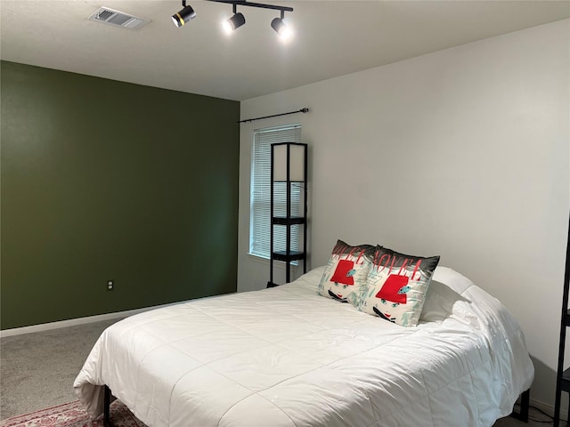 1518 Honea Egypt Rd, Magnolia, TX 77354 - bedroom with visible vents, baseboards, rail lighting, and carpet