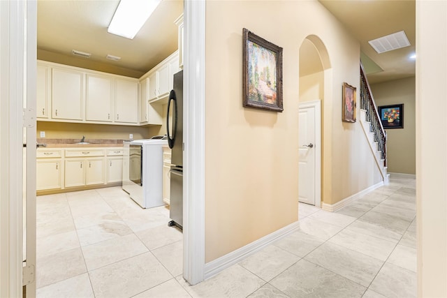 843 Royal Lakes Blvd, Richmond, TX 77469 - corridor featuring washer / dryer, light tile patterned floors, and visible vents