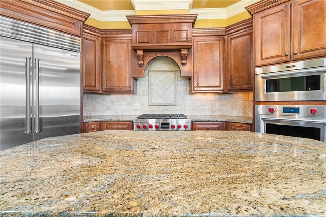 843 Royal Lakes Blvd, Richmond, TX 77469 - kitchen featuring light stone counters, ornamental molding, stainless steel appliances, and tasteful backsplash