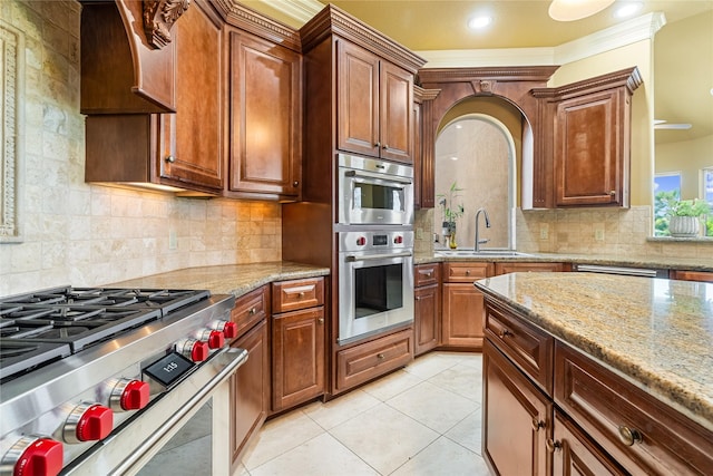 843 Royal Lakes Blvd, Richmond, TX 77469 - kitchen with a sink, light tile patterned floors, light stone countertops, and stainless steel appliances