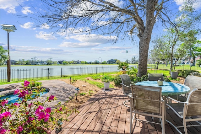 843 Royal Lakes Blvd, Richmond, TX 77469 - deck featuring outdoor dining area, a fenced backyard, and a water view