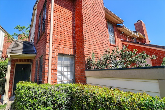 view of side of home with brick siding