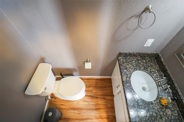 bathroom featuring vanity, baseboards, and toilet