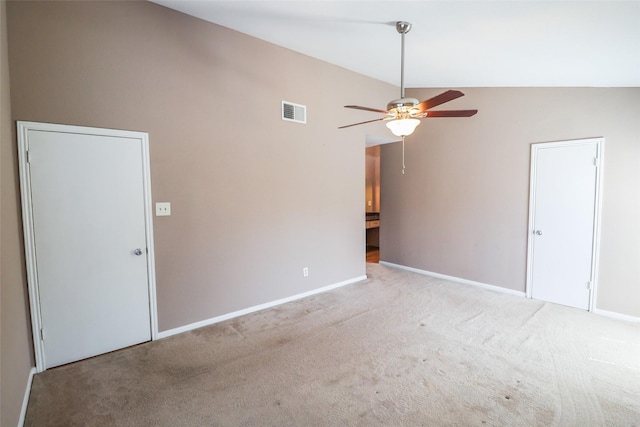 empty room featuring ceiling fan, visible vents, baseboards, lofted ceiling, and carpet
