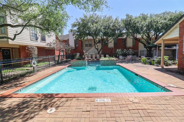 pool featuring fence and a patio area