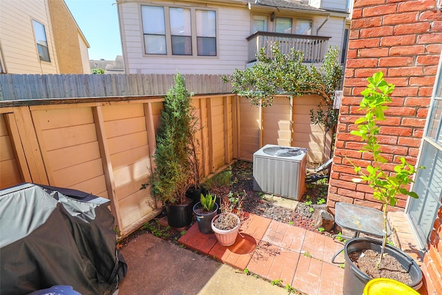 exterior space featuring central air condition unit, fence, and a patio
