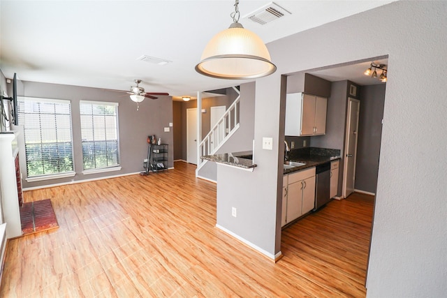 kitchen with visible vents, dark countertops, a ceiling fan, light wood-style flooring, and dishwasher