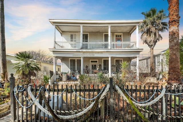 916 Sealy St, Galveston, TX 77550 - view of front of house featuring covered porch, a balcony, and fence