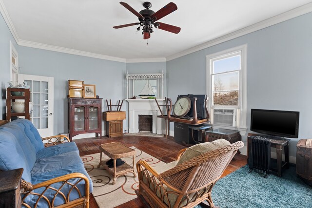 916 Sealy St, Galveston, TX 77550 - living room with cooling unit, a ceiling fan, wood finished floors, a fireplace with flush hearth, and crown molding