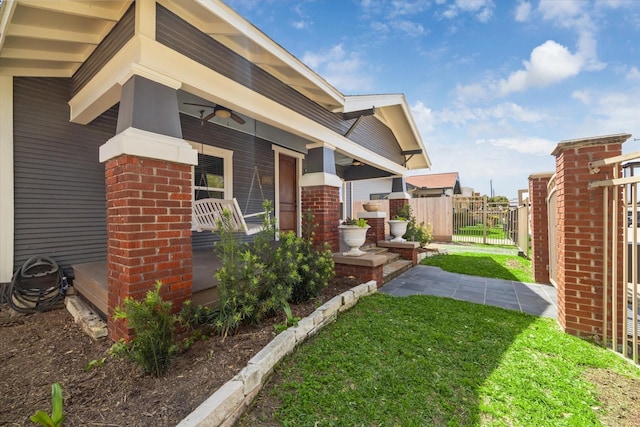 2615 White Oak Dr, Houston, TX 77009 - exterior space featuring fence, brick siding, a gate, covered porch, and a yard