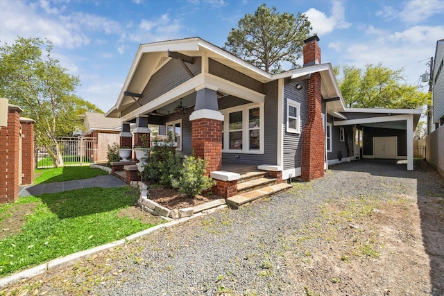 2615 White Oak Dr, Houston, TX 77009 - view of front of home featuring fence, a carport, a chimney, and gravel driveway