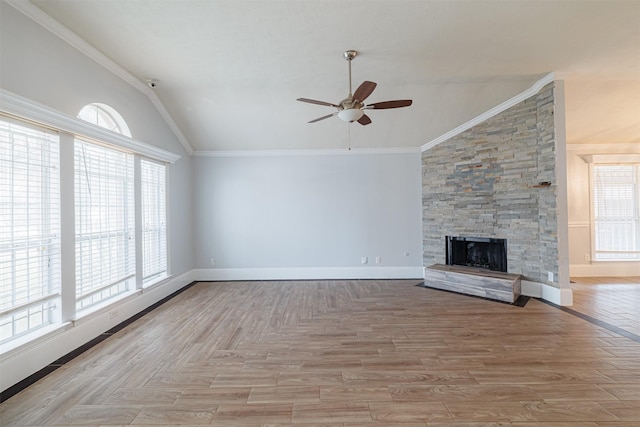unfurnished living room featuring baseboards, ceiling fan, crown molding, and vaulted ceiling