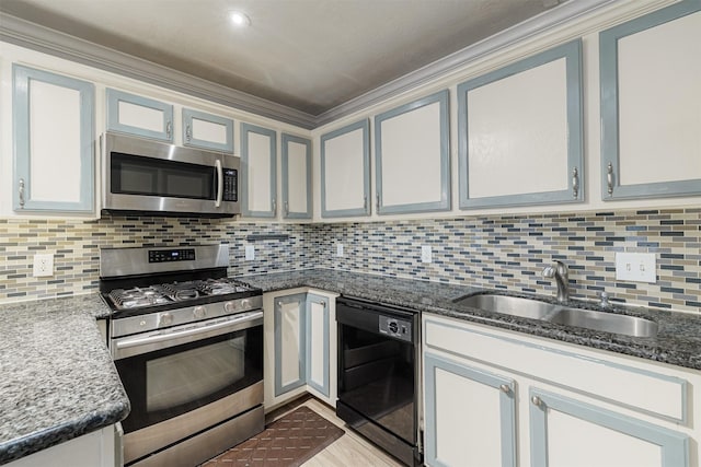 kitchen with a sink, tasteful backsplash, appliances with stainless steel finishes, and dark stone countertops