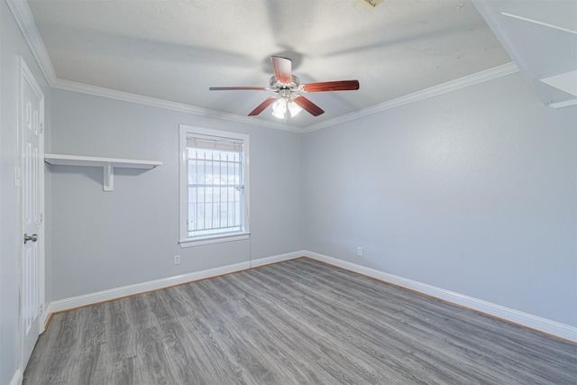 unfurnished room featuring baseboards, crown molding, ceiling fan, and wood finished floors