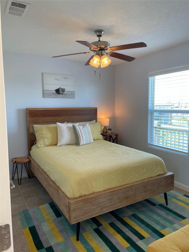 bedroom with visible vents and a ceiling fan