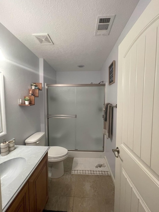 full bath with visible vents, toilet, a stall shower, and vanity