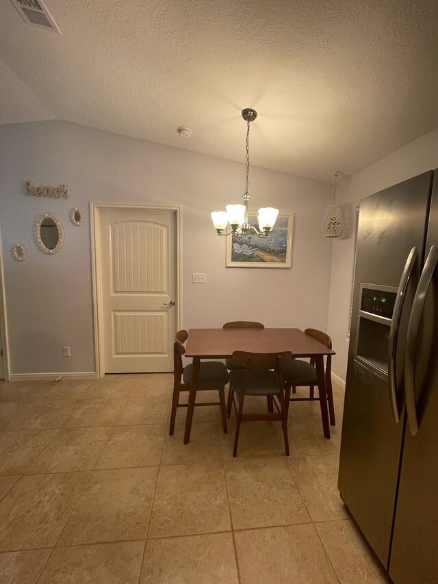 dining room featuring a textured ceiling, light tile patterned floors, visible vents, and a chandelier