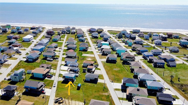 birds eye view of property with a residential view, a beach view, and a water view